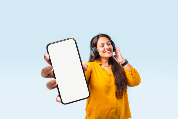 istock Indian asian young woman showing big smartphone with empty screen 2163894664