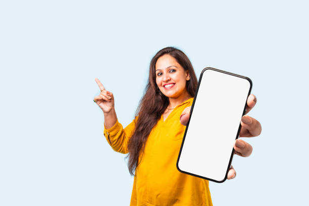 istock Indian asian young woman showing big smartphone with empty screen 2163894666