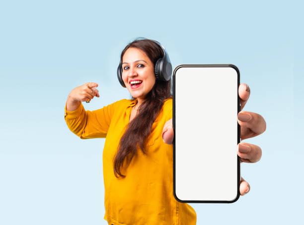 istock Indian asian young woman showing big smartphone with empty screen 2163894675