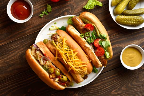 istock Hot dogs with different toppings on wooden background 2163896900