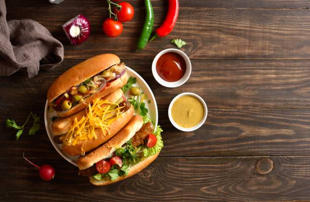 istock Hot dogs with different toppings on wooden background 2163896974