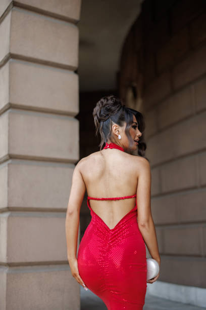 istock Lady in red on outdoor staircase 2163897295