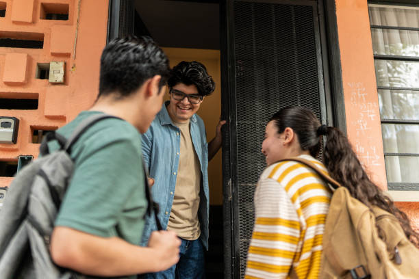 Young students greeting at house