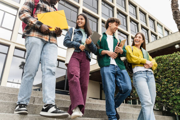 istock University Students Walking College staircase Holding Books And Laughing, after classes and exams 2163900588