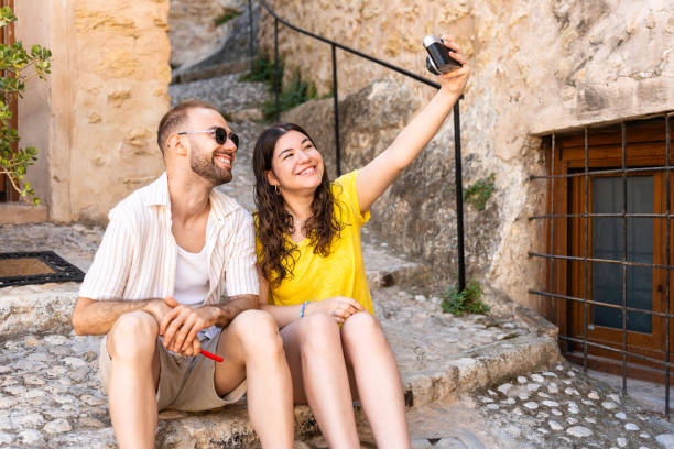 istock Couple taking a selfie with an old camera. 2163901424