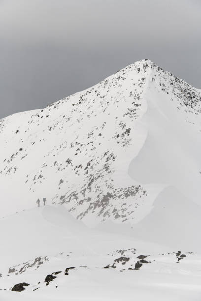 istock Side view of a tall mountain with a sharp peak partially 2163903042