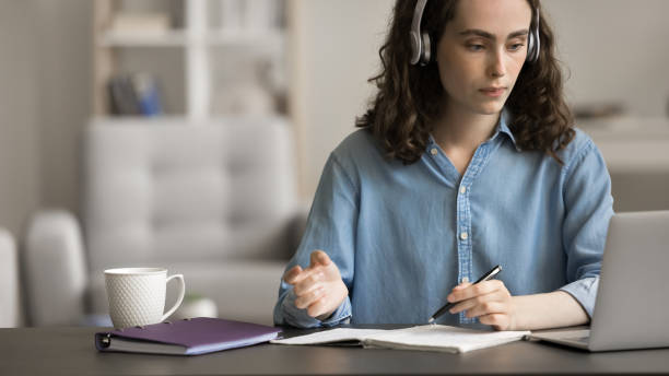 istock Serious attractive student girl e-learning, listening audio course 2163904881