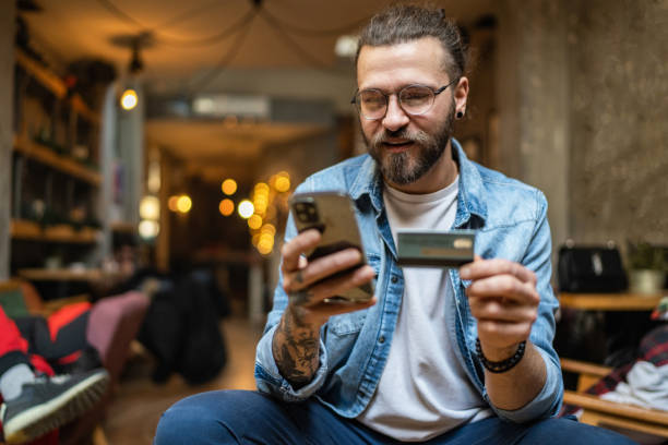 istock Young man shopping online or checking bank account using cell phone 2163906640