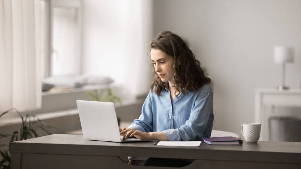 istock Attractive young woman working on studying on-line on laptop 2163906641