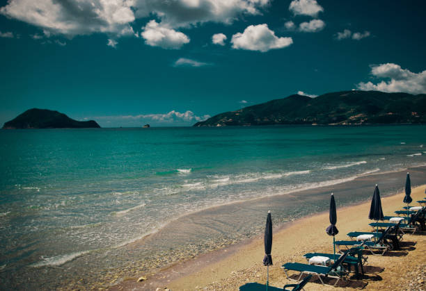 travel concept - sunchairs with  umbrellas on beautiful  beach, Zakynthos  island, Greece