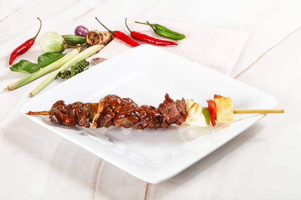 Asian grilled beef skewer with vegetables and pineapple - Satay