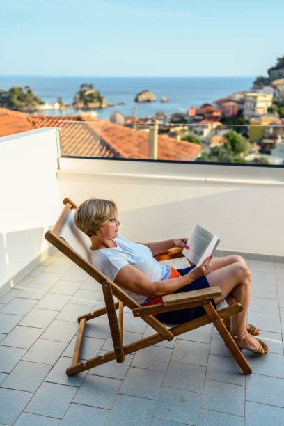 istock Woman reading a book on the balcony 2163914242