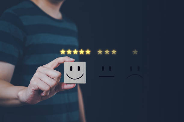 istock Satisfaction concept, Man holding square wooden board with smiling face icon 2163918730
