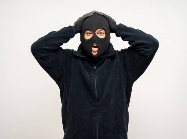 istock Thief in uniform black jacket various pose on isolated background. The Robber terrorism criminal escapes with balaclava and crowbar entering a house for stealing Housebreak 2163921635