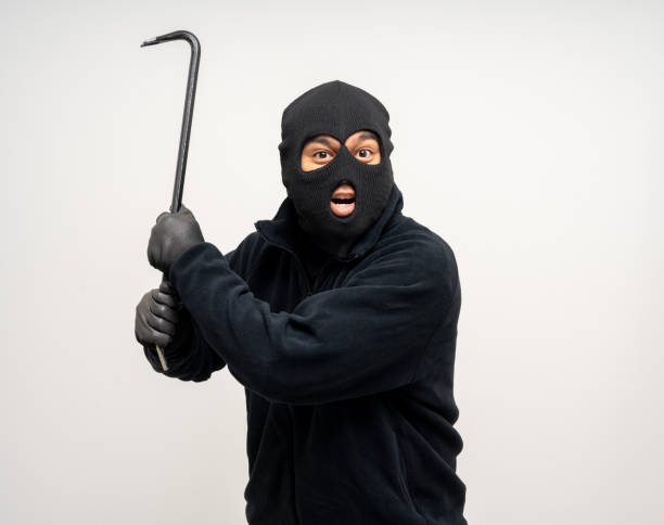 istock Thief in uniform black jacket various pose on isolated background. The Robber terrorism criminal escapes with balaclava and crowbar entering a house for stealing Housebreak 2163922184