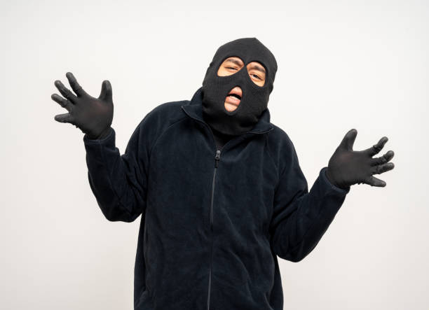istock Thief in uniform black jacket various pose on isolated background. The Robber terrorism criminal escapes with balaclava and crowbar entering a house for stealing Housebreak 2163922193