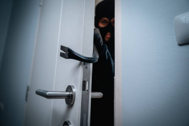 istock Thief in uniform black jacket various action housebreak. The Robber terrorism criminal escapes with balaclava and crowbar entering a house for stealing Housebreak at night 2163923355