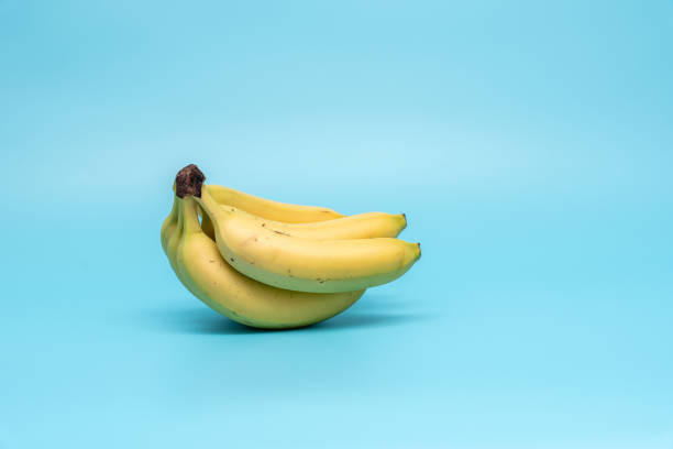 istock Ripe bananas on a blue background. 2163923750