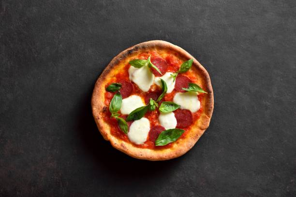 istock Pizza with mozzarella, pepperoni, tomato sauce and basil 2163924291