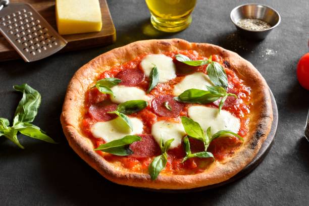 istock Pizza with mozzarella, pepperoni, tomato sauce and basil 2163924295