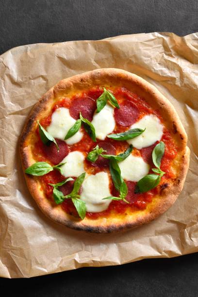 istock Pizza with mozzarella, pepperoni, tomato sauce and basil 2163924304