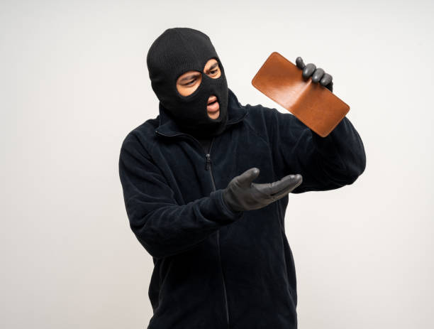 istock Thief in uniform black jacket various pose on isolated background. The Robber terrorism criminal escapes with balaclava and crowbar entering a house for stealing Housebreak 2163924312