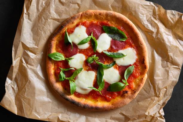 istock Pizza with mozzarella, pepperoni, tomato sauce and basil 2163924316