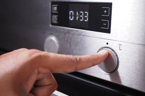 istock Adjusts temperature on oven for precise baking, providing culinary convenience for home chefs 2163926261