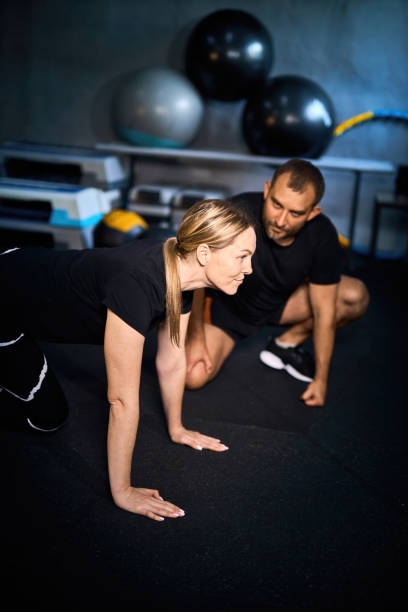 istock Young sportswoman doing push-ups during exercise 2163927188