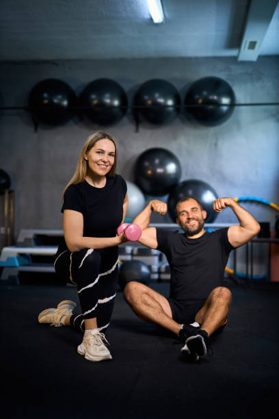 istock Happy athletic couple flexing their muscles after working out 2163927374