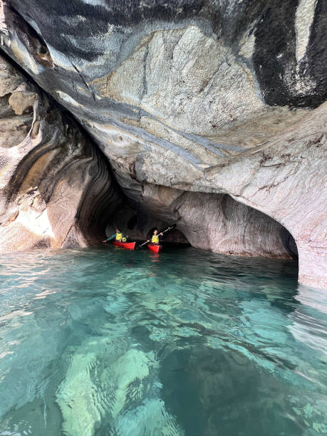 Kayaking through caves, Patagonia Kayaking through caves, Catedral de Marmol, Carretera Austral, Patagonia carretera austral chile stock pictures, royalty-free photos & images