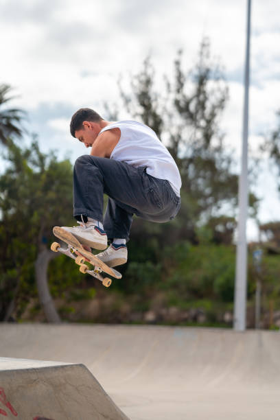 istock young man skater jumping a ramp in a skate park. vertical composition 2163933116
