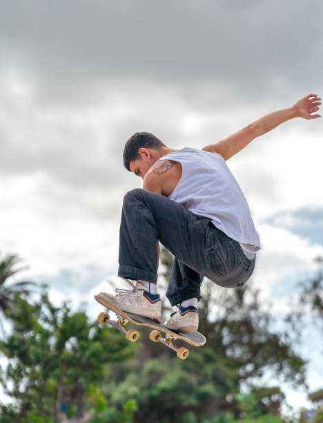 istock young man skater jumping a ramp in a skate park. vertical composition 2163933123