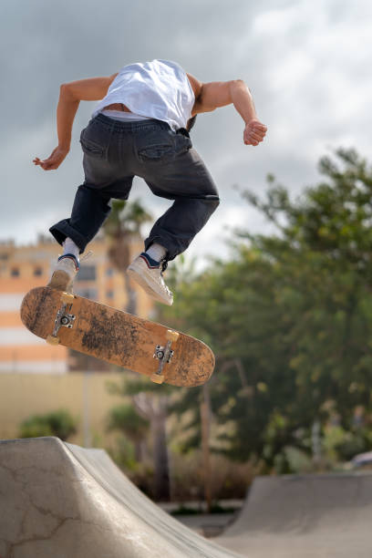 istock young man skater jumping a ramp in a skate park. vertical composition 2163933152