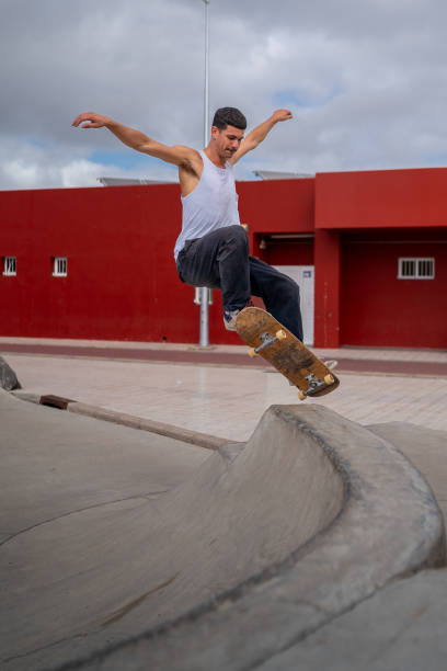 istock young man skater jumping a ramp in a skate park. vertical composition 2163933167