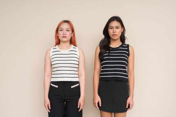 istock Portrait of Two Beautiful Woman Outdoors Studio Shot Against Plain Background With Plain Expression 2163935100