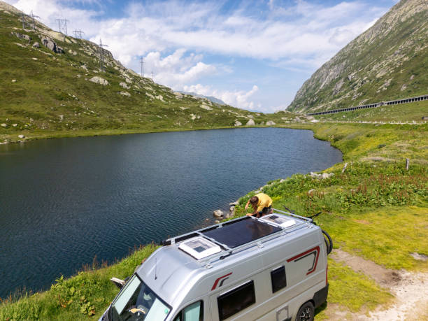 istock Camper Van Solar Panel Maintenance at Mountain Lake 2163940486