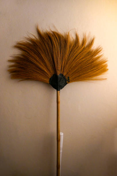 istock Antique grass broom in upside down position, warm color. 2163941315