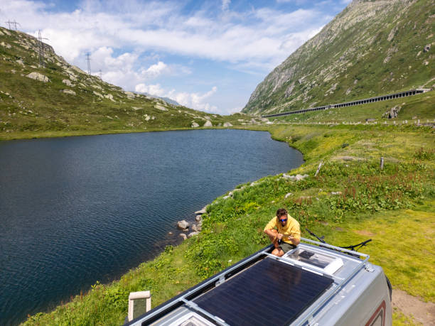 istock Scenic Mountain Lake Solar Panel Setup on Camper Van 2163941441