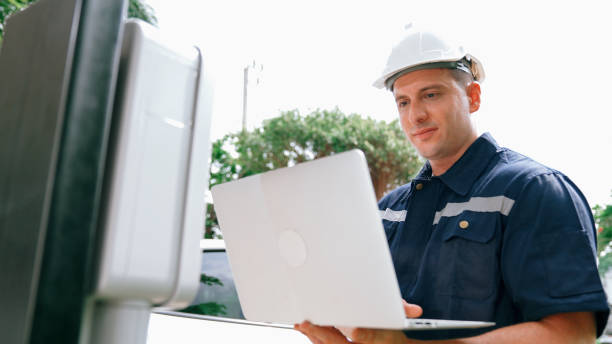 istock Qualified technician working with laptop for home EV station. Synchronos 2163948560