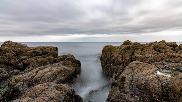 istock Water rushing between rocks on cloudy day in scotland 2163951607