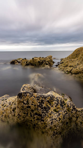 istock Ocean flowing around moss covered rocks on the scottish coastline 2163951638