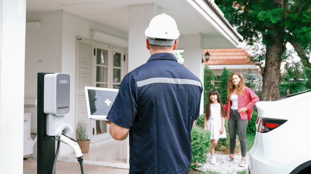 istock Qualified technician working with laptop for home EV station. Synchronos 2163953358