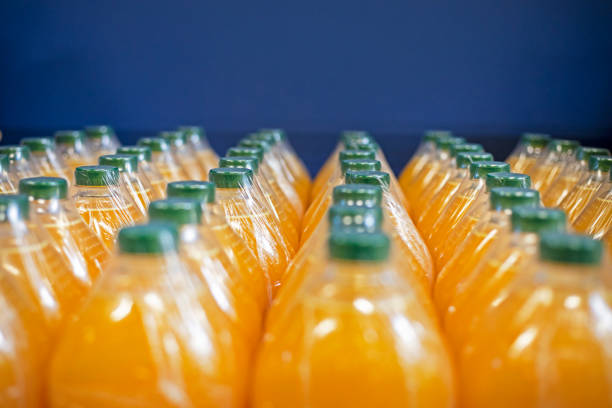 istock orange juice and other drinks packed in plastic containers with green plastic lids 2163966821