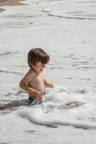 Boy playing on the seashore on the beach.