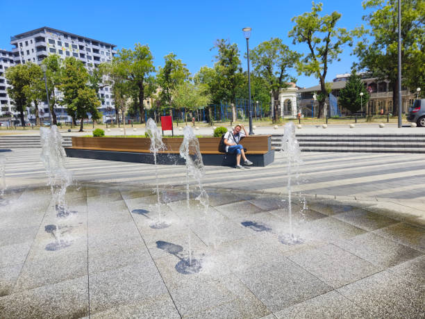 Tourist visit European town in sunny summer day and catching moments of joy with mobile phone