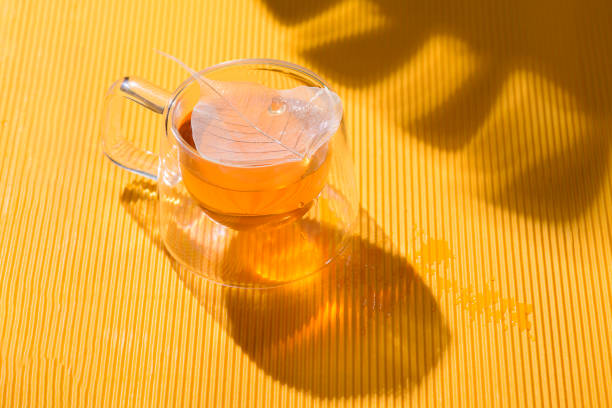 Black tea with camomile on white background. Isolated