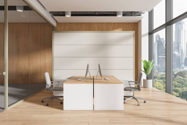 istock Glass coworking interior with two armchairs and desks, pc computers and window 2163970750