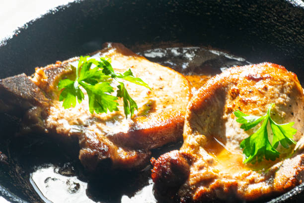 Pork chops fried on the cooking pan