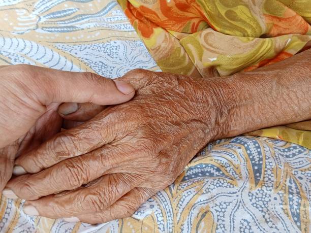 istock The hands of elderly people 2163972012